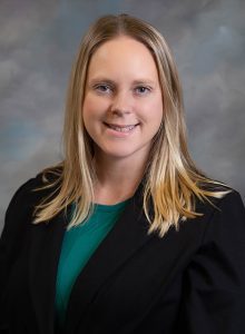 Rachel Wilkerson, Customer Care Team Manager - smiling headshot with blonde hair, black blazer over dark teal shirt, and gray background