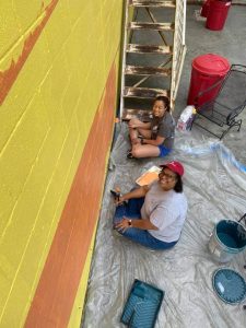 Local bankers painting a mural at Fulton, MO business | Community Bank