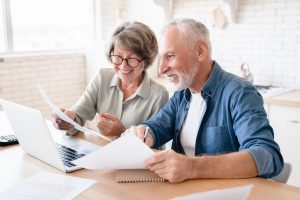 Image features homeowners reviewing insurance premium paperwork | Local Bank in Columbia, MO