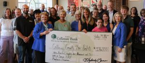 Check presentation for $186,000 donation to 5 area non-profits.